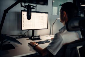 man in white polo shirt sitting in front of computer